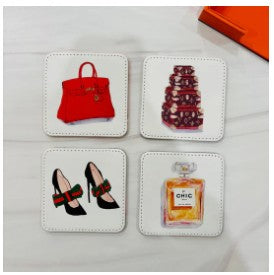 Includes: set of 4 coasters (reversible designs) with holder
Made from Vegan Leather 
Dimensions: 3.5" square
Hand wash; do not soak, dry promptly